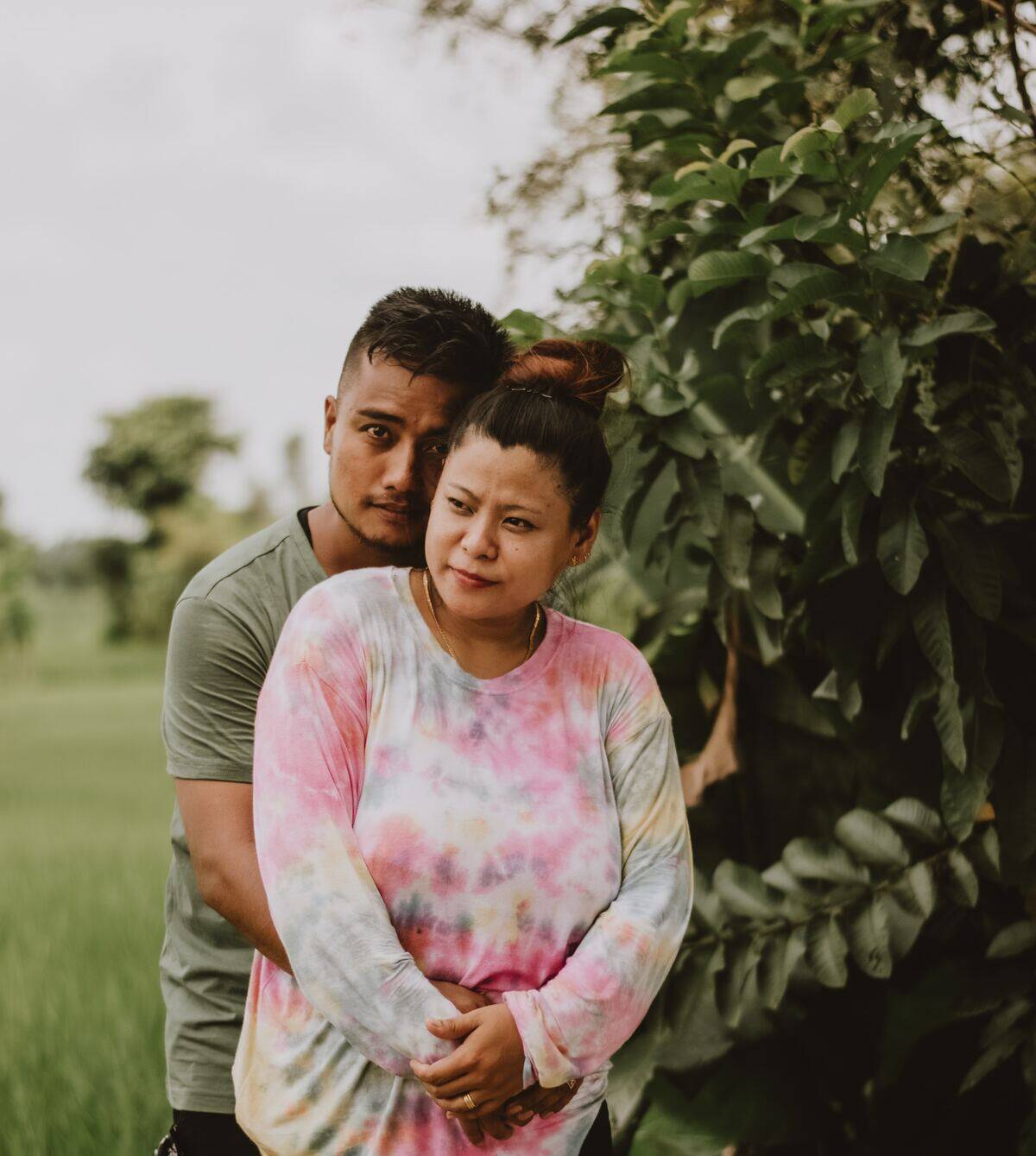 couple cuddling forlornly in nature