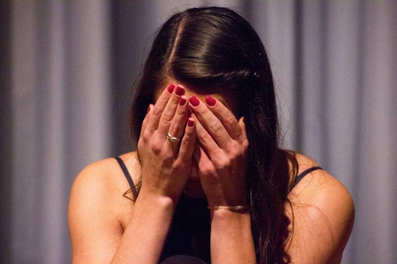 woman burying her face in her hands