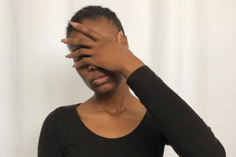 woman putting hand over her face in exasperation