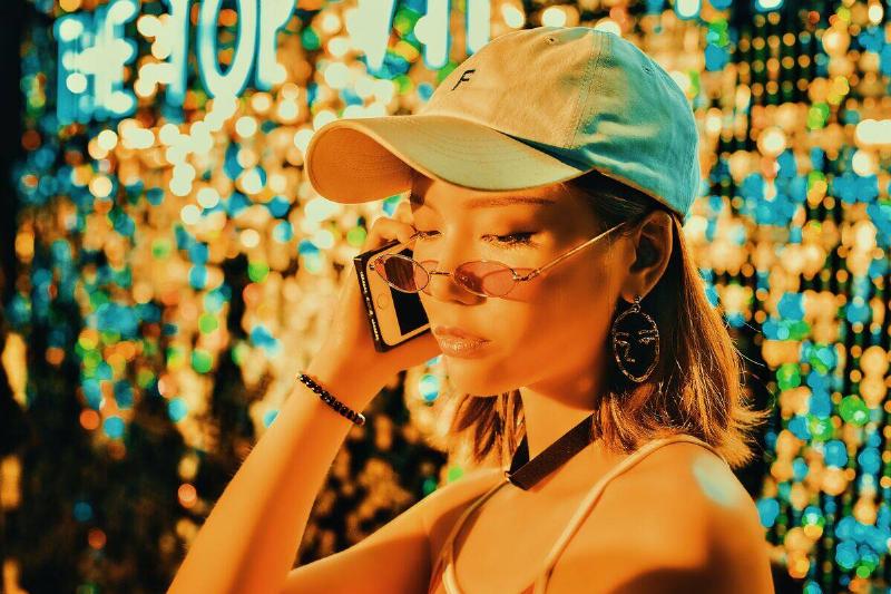 woman tlaking on phone with sullen expression
