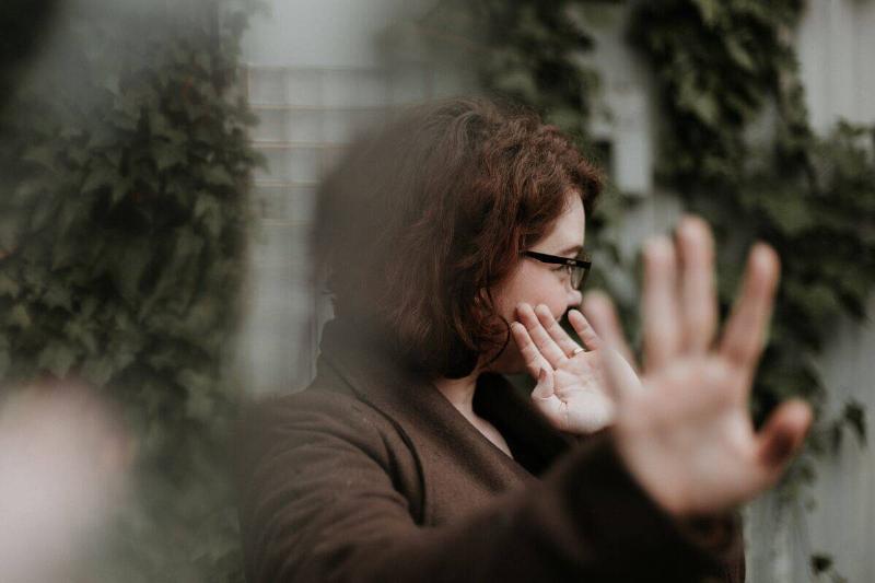 woman turning her head with her hands out