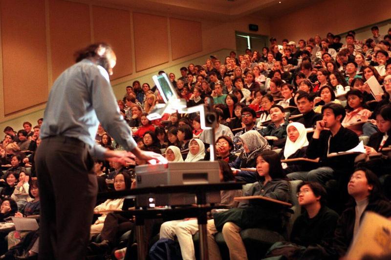 University of Melbourne students in the Public Lecture Theatre, where teacher is using an overh