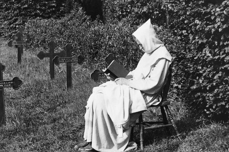 Trappist Monk Reads in Cemetery