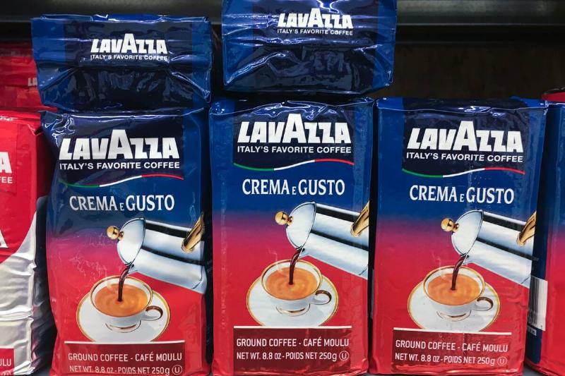 Packs of Lavazza powdered coffee stacked on a shelf. Luigi...