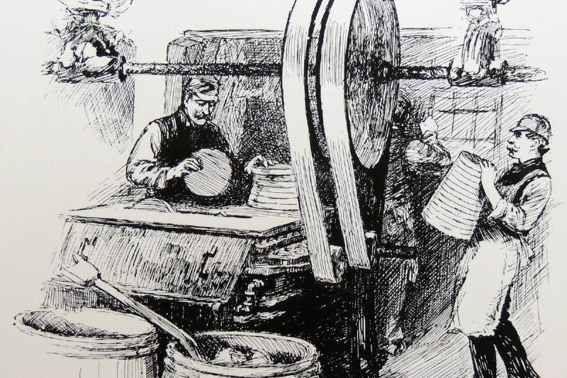 Sawing cones of sugar into lumps