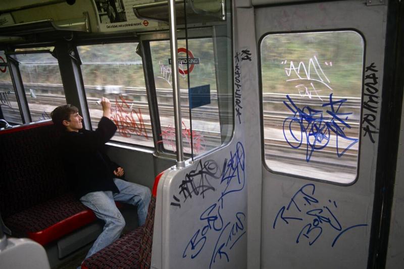 England - London - Young graffiti tagger on underground train