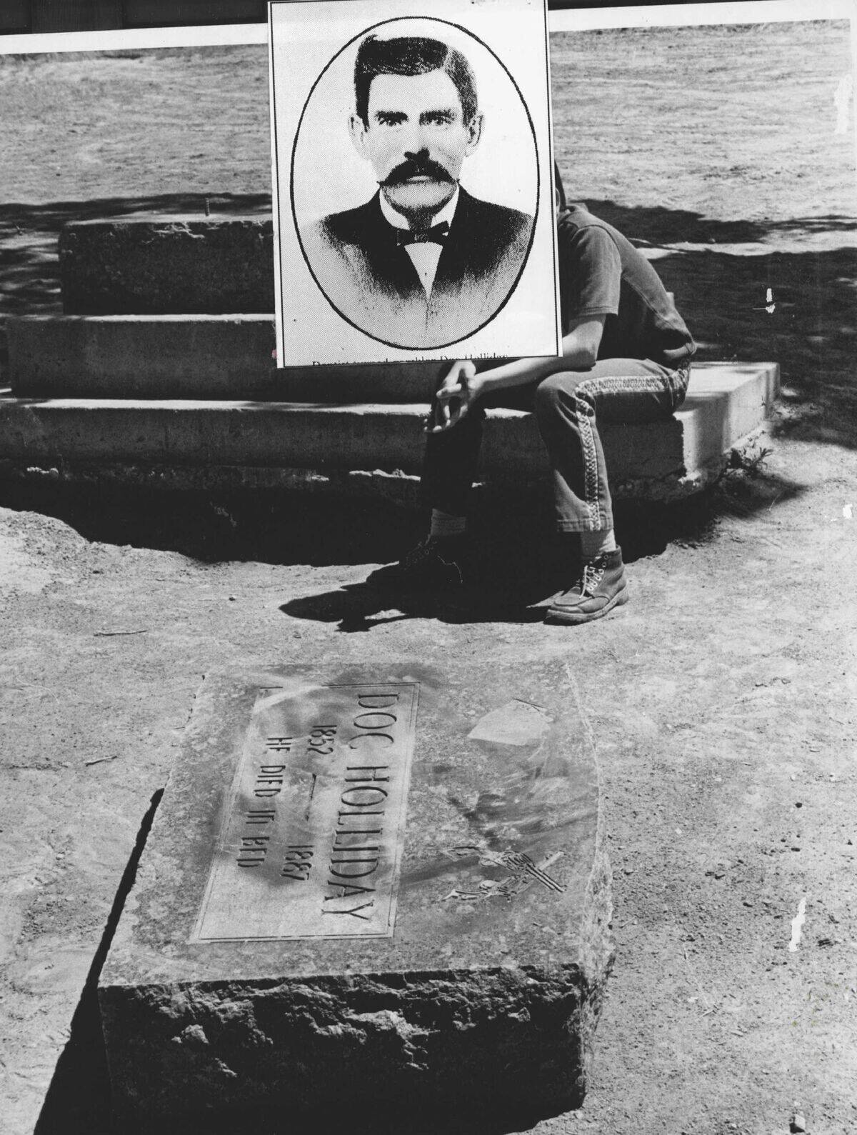 MAY 11 1974, MAY 13 1974; Western Gunfighter's Grave Desecrated; A young tourist studies the toppled
