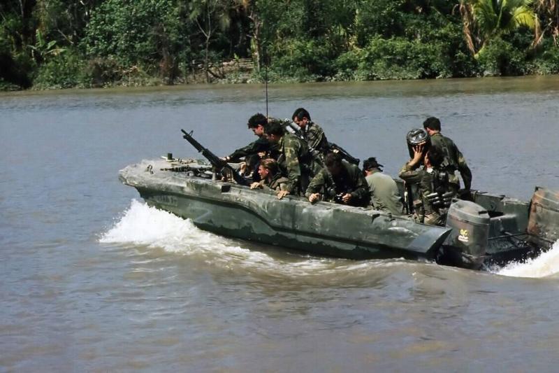 Vietnam: Members of a US Navy SEAL team move down the Hau Giang or Bassac River in a SEAL Team Assault Boat (STAB) near Saigon, November 1967