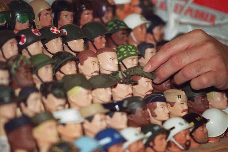 Vendors position heads of dolls prior to the openi