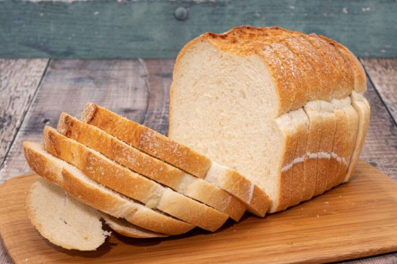 Sliced loaf of bread on a wooden cutting board