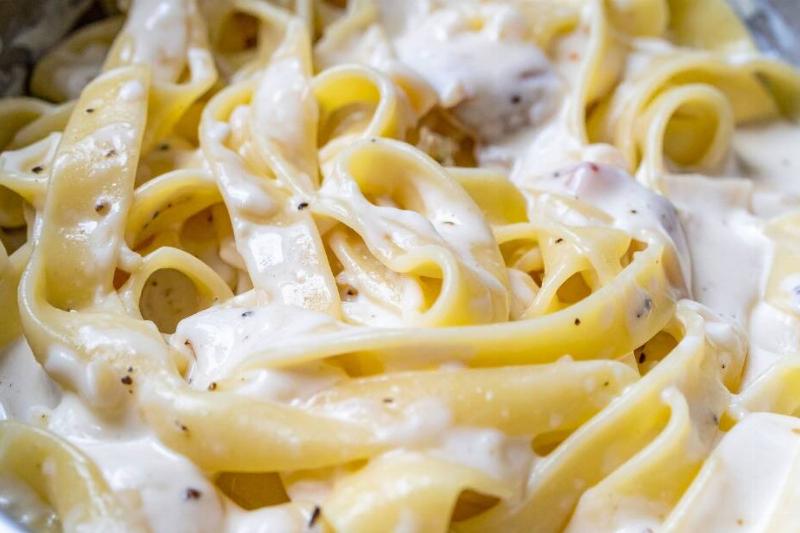 Pasta noodles covered in a white cream sauce