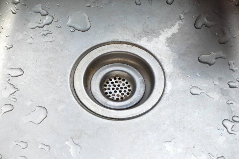 Close-up of the drain in a metal sink