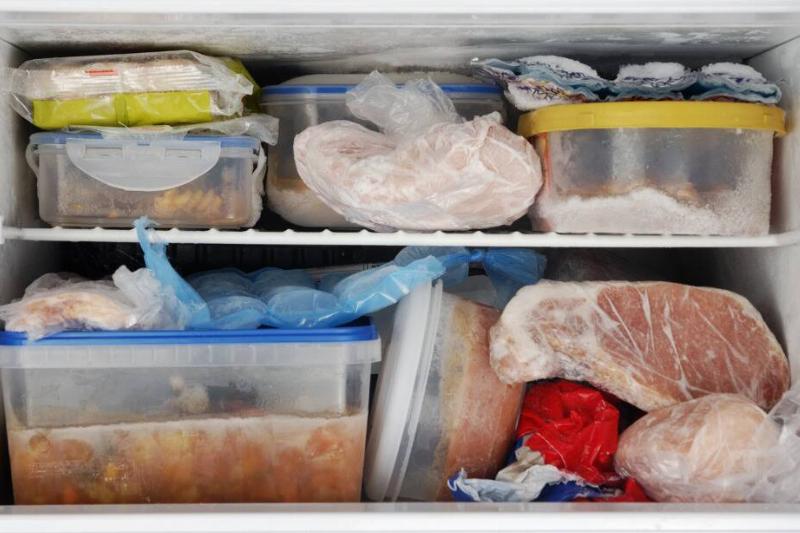Freezer filled with various containers and bags