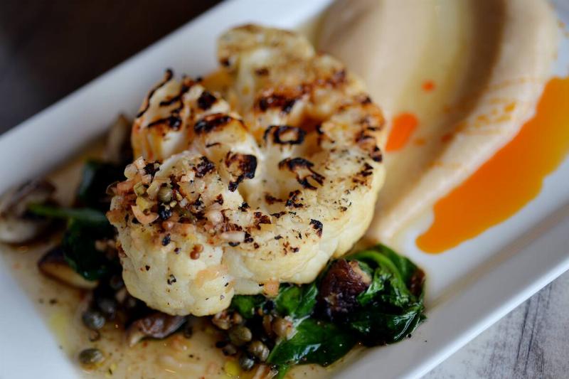 Cauliflower steak on a plate with sauce