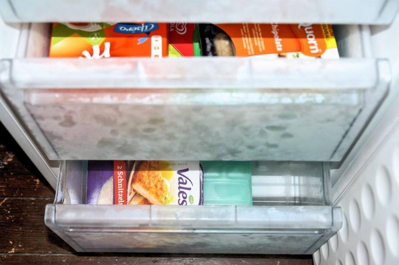 Two freezer drawers filled with items, slightly ajar