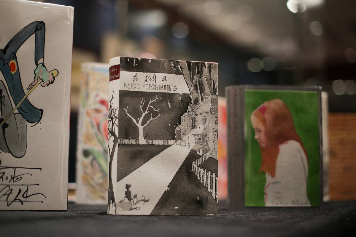 'To Kill a Mockingbird' on display next to other books on a shelf