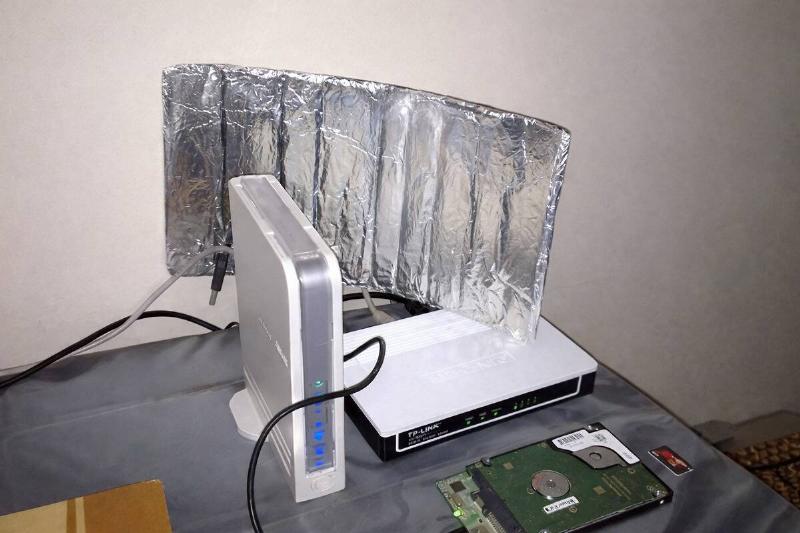 AI rendering of tin foil placed around a Wi-Fi router atop a desk
