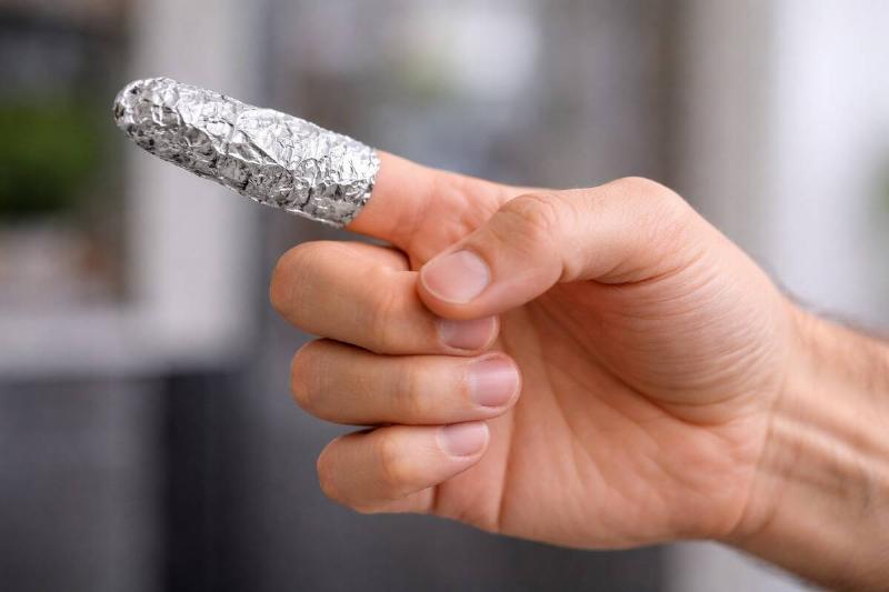 AI rendering of an outstretched hand that has the index finger wrapped in aluminum foil