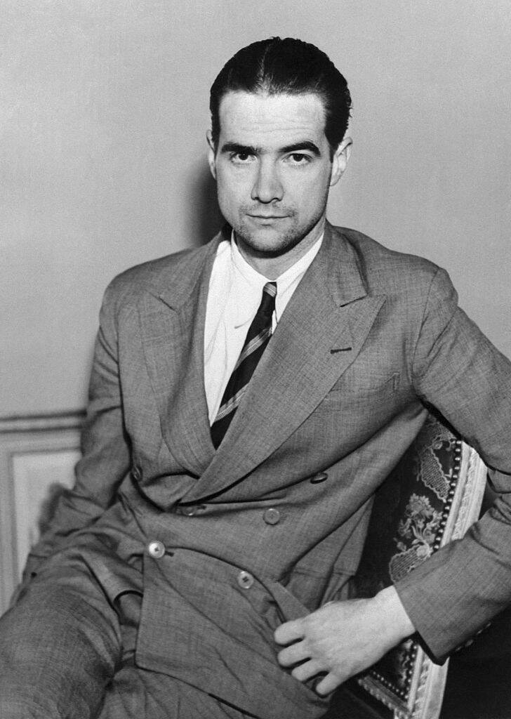 Howard Hughes sitting in a chair