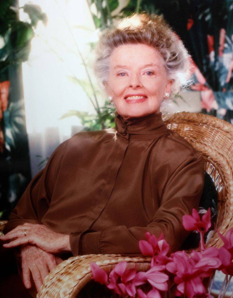 Katharine Hepburn sitting in a wicker chair