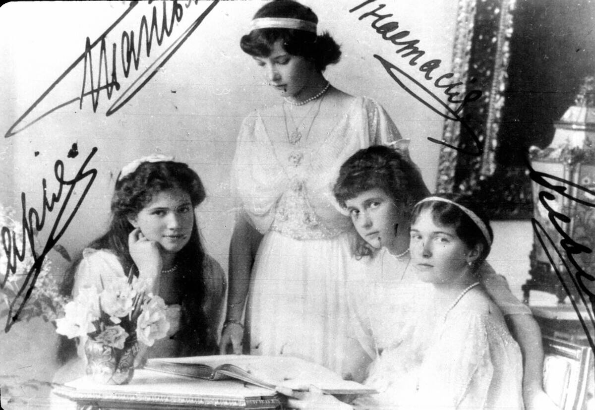 Grand Duchesses Maria, Tatiana, Anastasia and Olga sitting at a small table