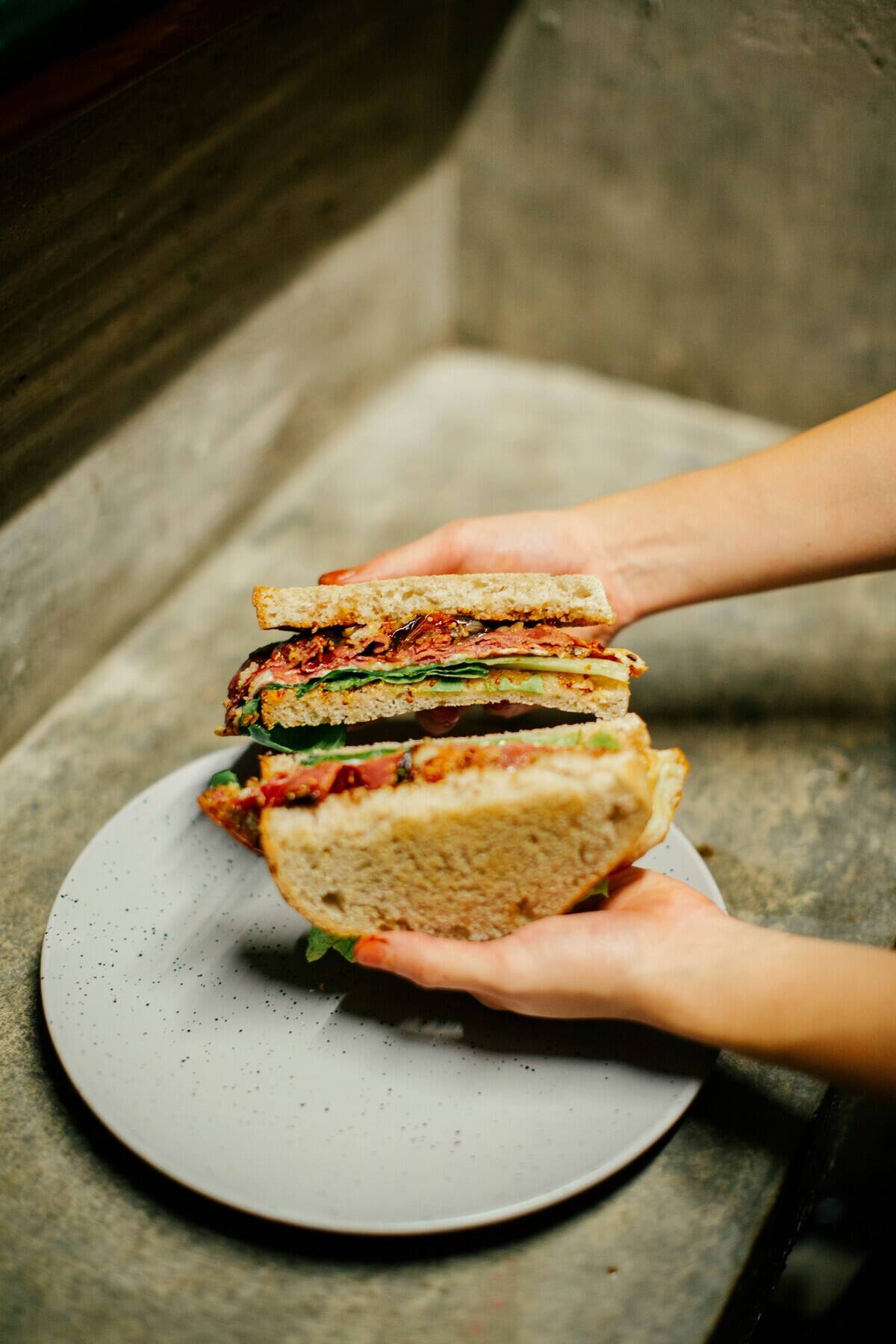 Person holding open a sandwich