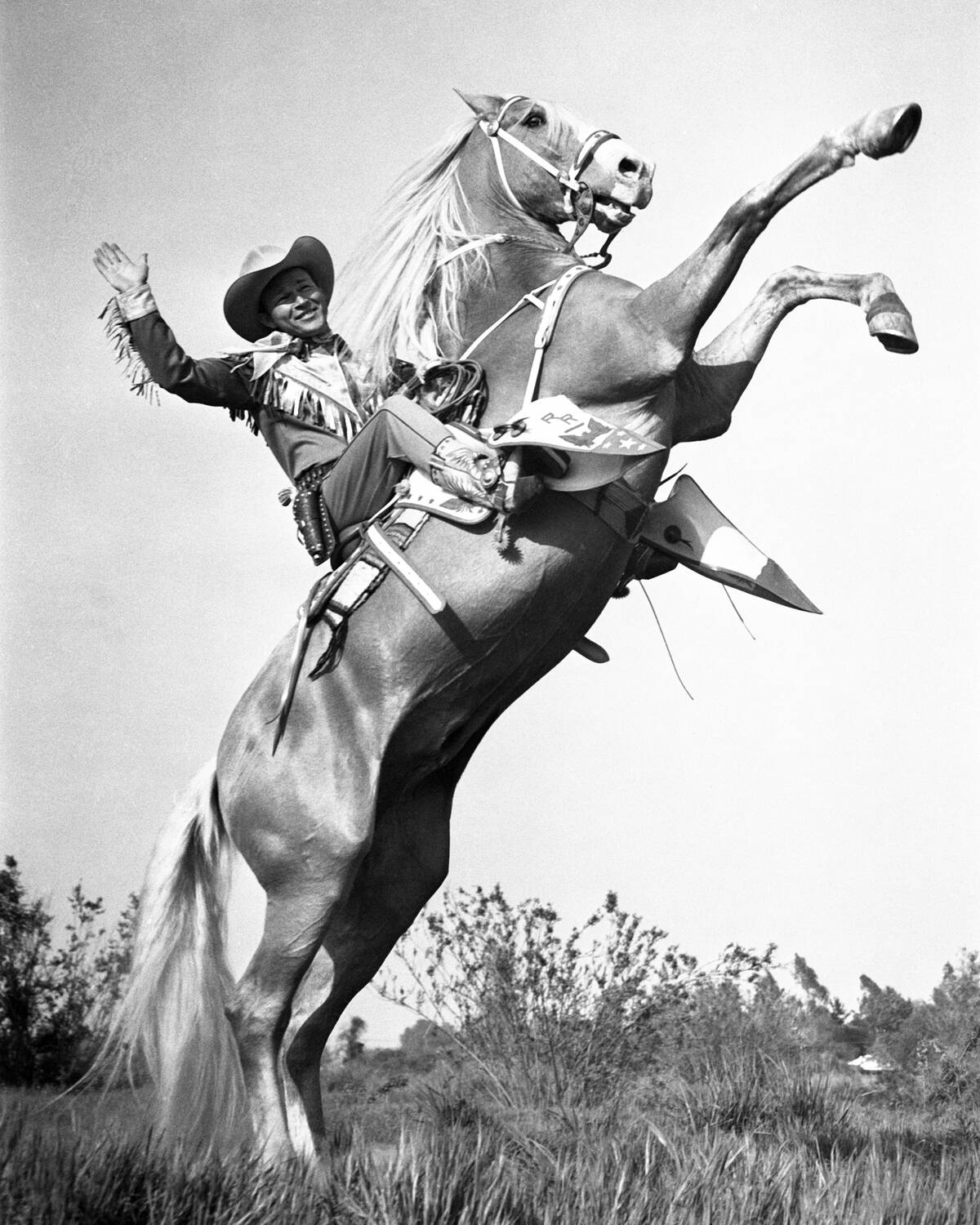 Roy Rogers sitting on the back of Trigger, who is rearing up
