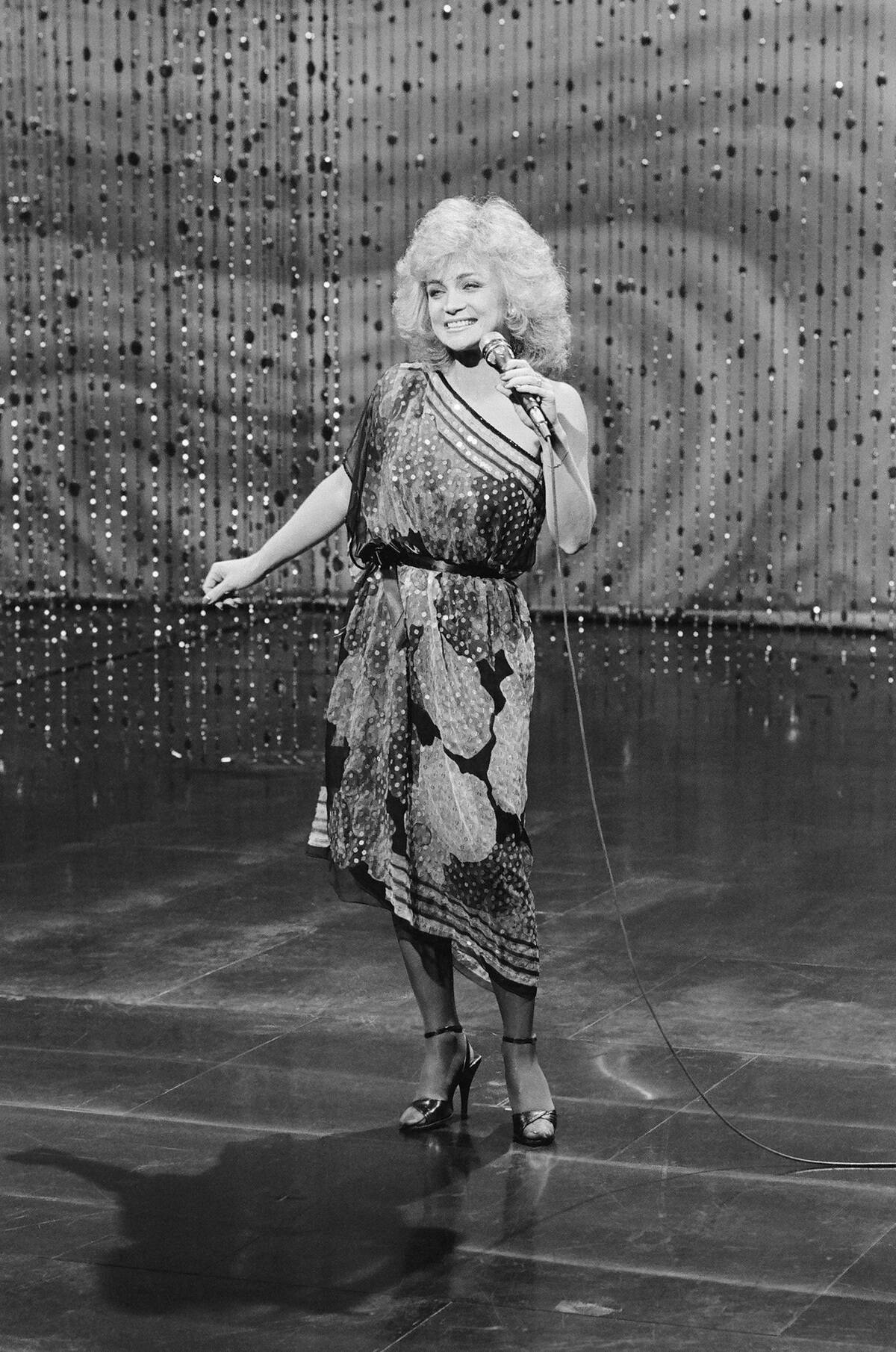 Barbara Mandrell standing on stage