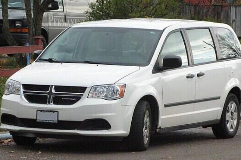 White 2013 Dodge Grand Caravan parked on the side of a road