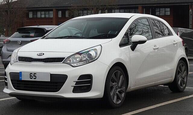 White 2015 Kia Rio parked in a spot