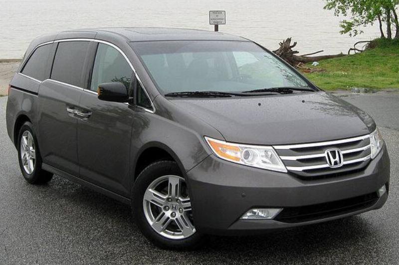 Black 2011 Honda Odyssey parked near water