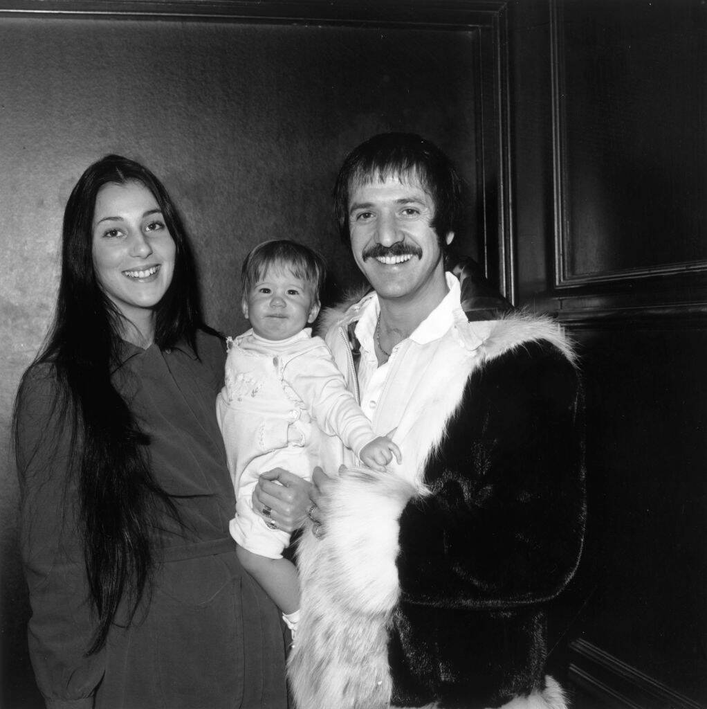 Cher and Sonny Bono standing together, with Sonny holding Chaz Bono