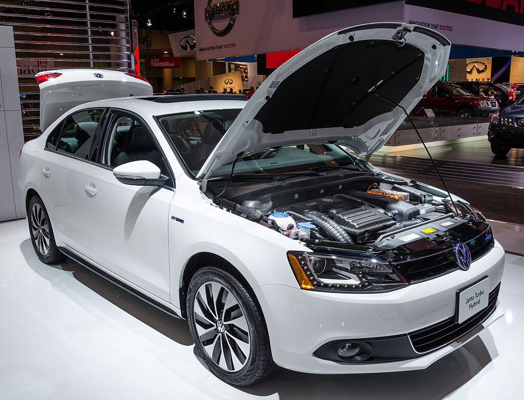 White 2013 Volkswagen Jetta with its hood propped up and its trunk open