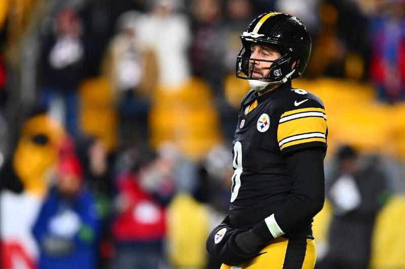 Aaron Rodgers turned to the side, wearing his football gear