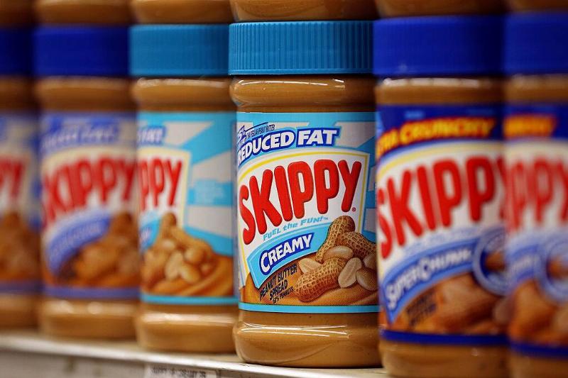 Jars of SKIPPY peanut butter on a grocery store shelf