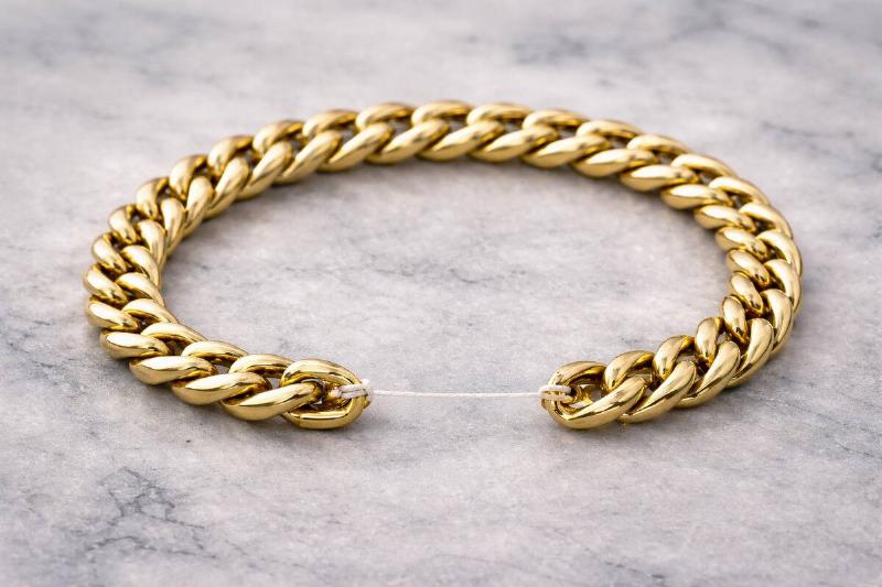 Gold bracelet being held together with dental floss