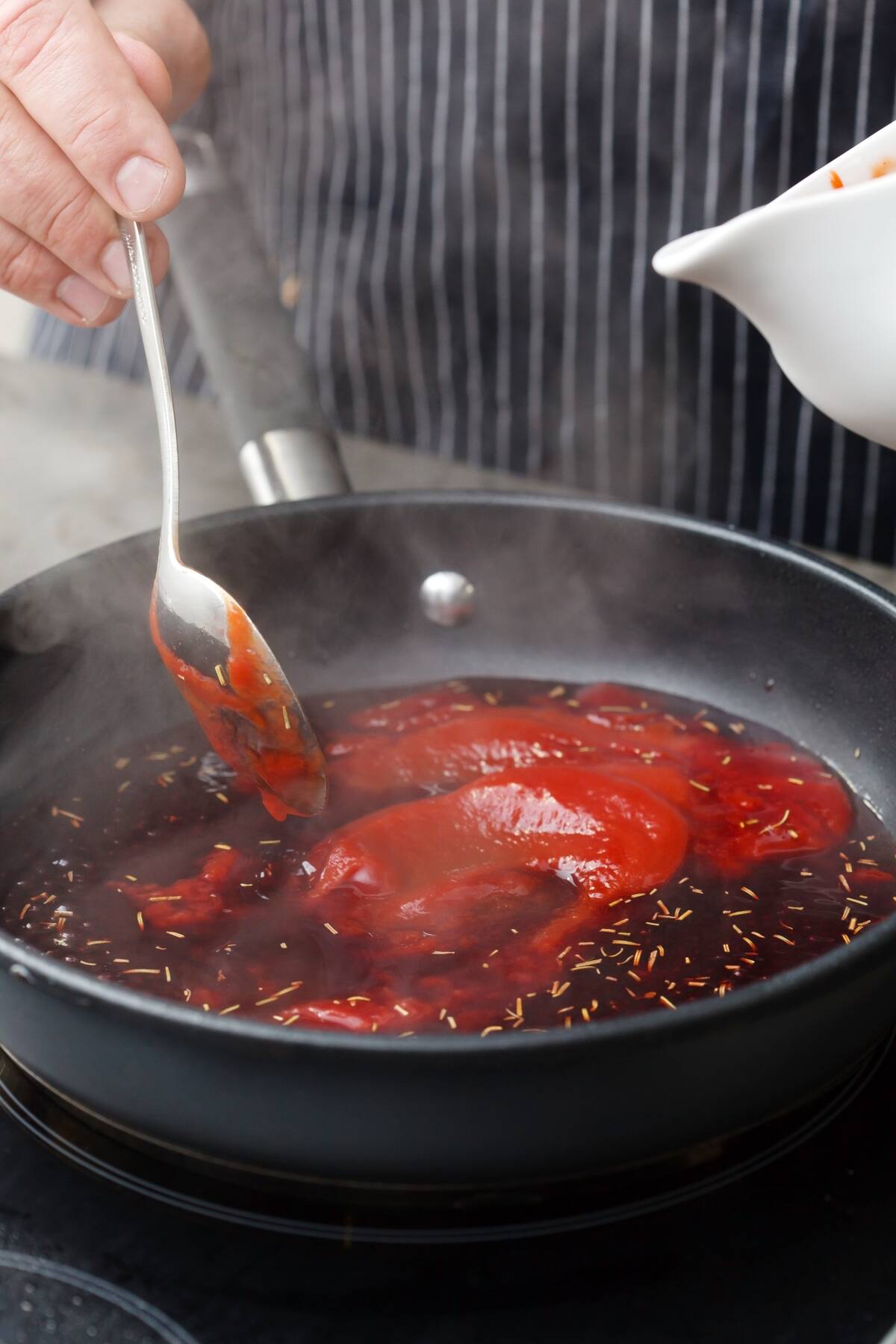 Close-up of a sauce pan filled with red sauce