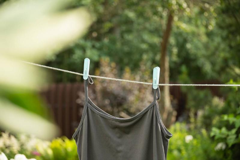Sleeveless shirt hanging from an outdoor clothesline