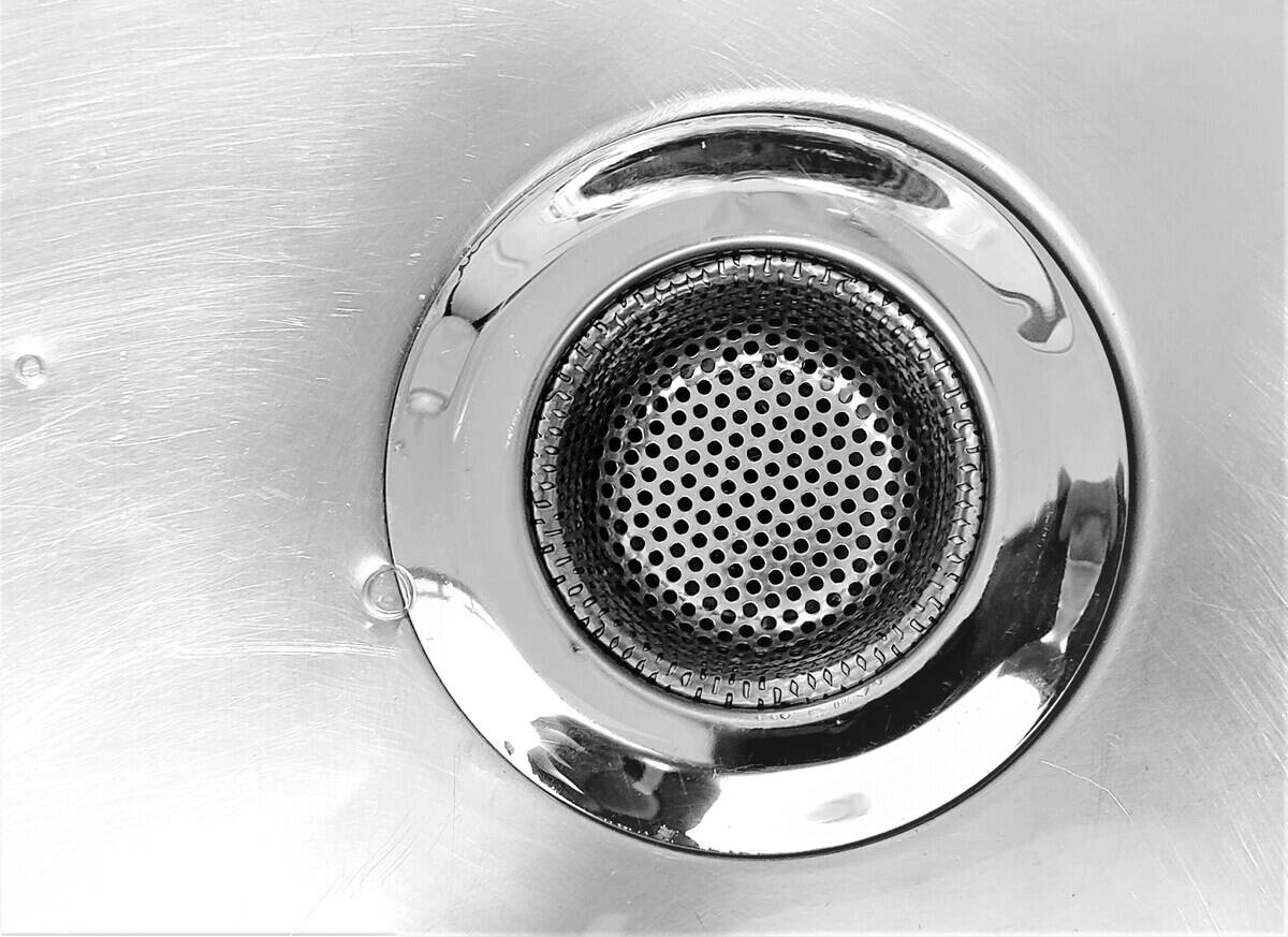 Close-up of the drain in a metal sink