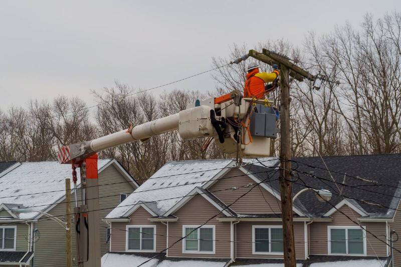 Electrical worker in the air, working on a power line