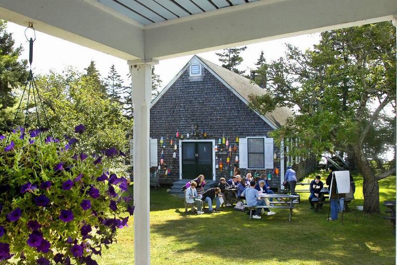Framed by the Queen Mary Building's veranda, a class of Audubon Chapter leaders enjoys the weather o