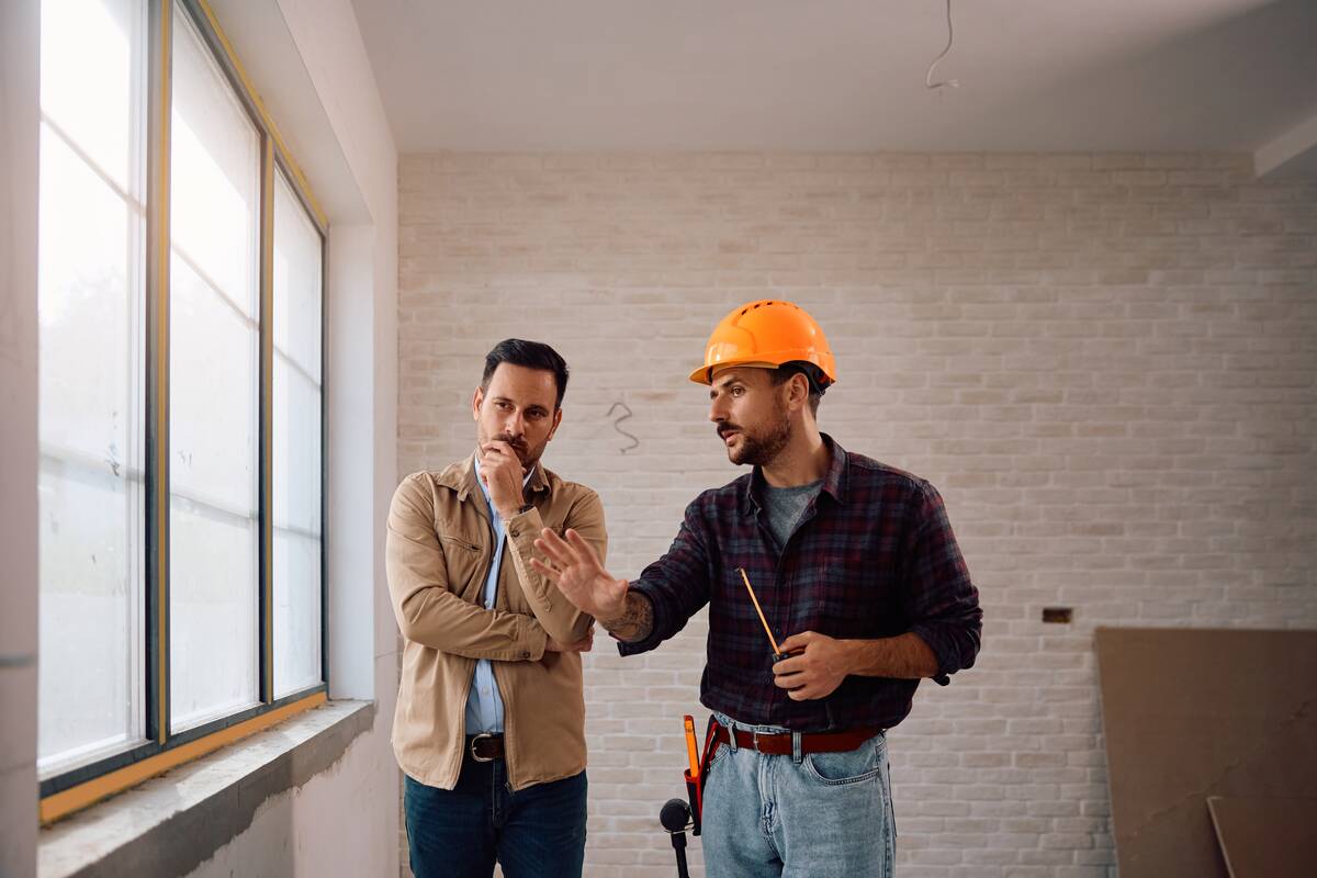 Contractor speaking to a man who's looking inquisitive