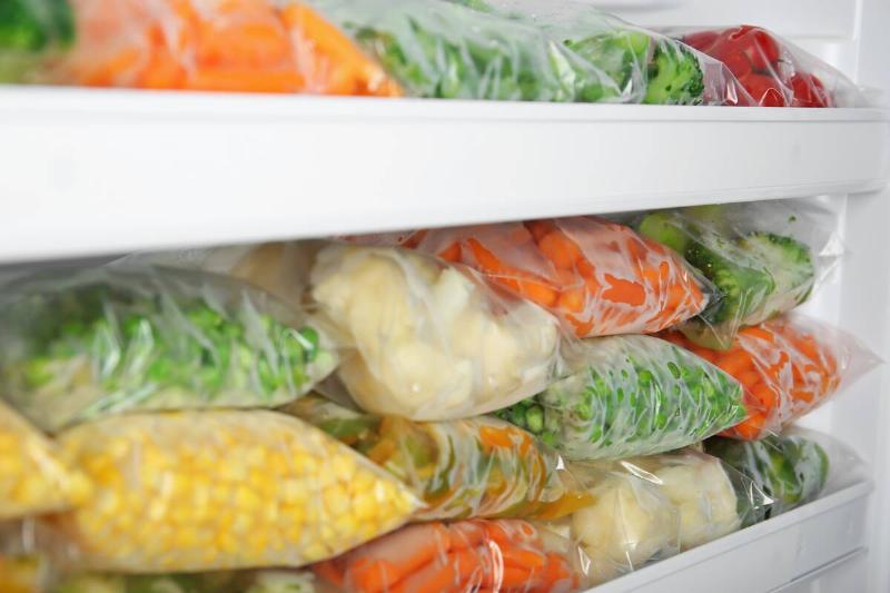 Bags of vegetables in a freezer