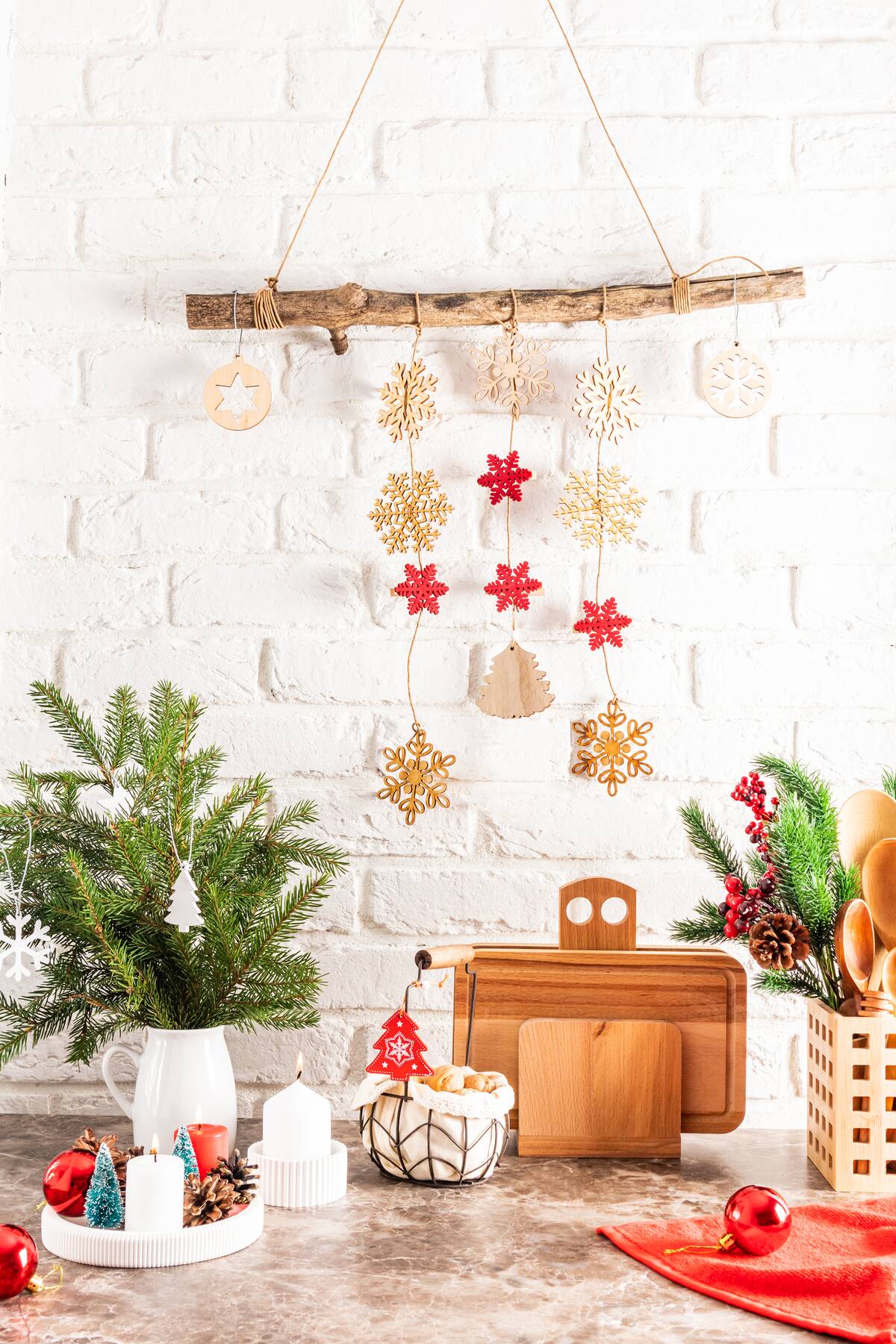 Christmas decorations hanging on the wall, over a kitchen counter