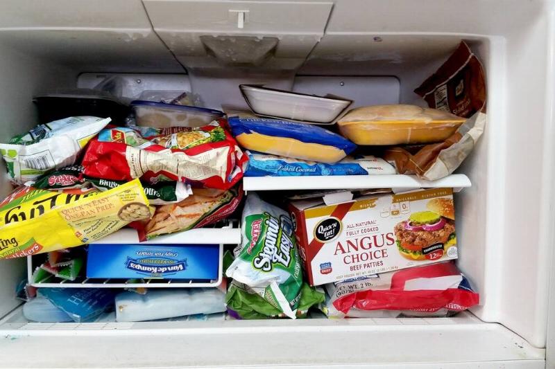 Boxes and bags of food in a freezer
