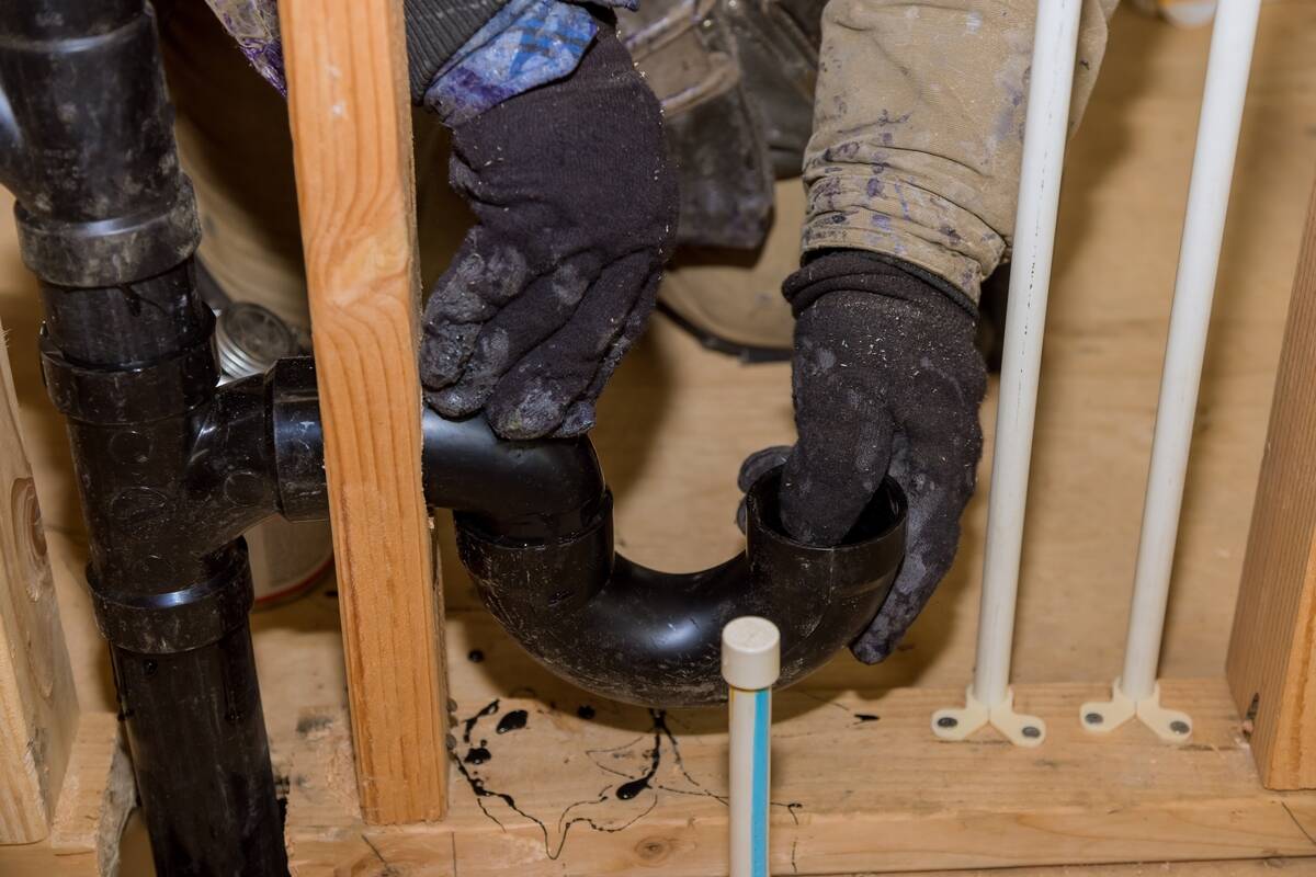 Black piping beneath a sink