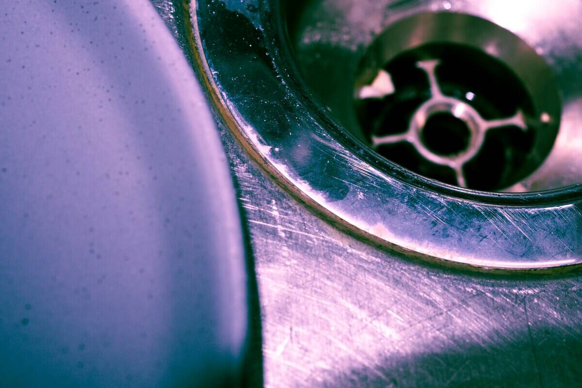 Close-up of the drain in a metal sink