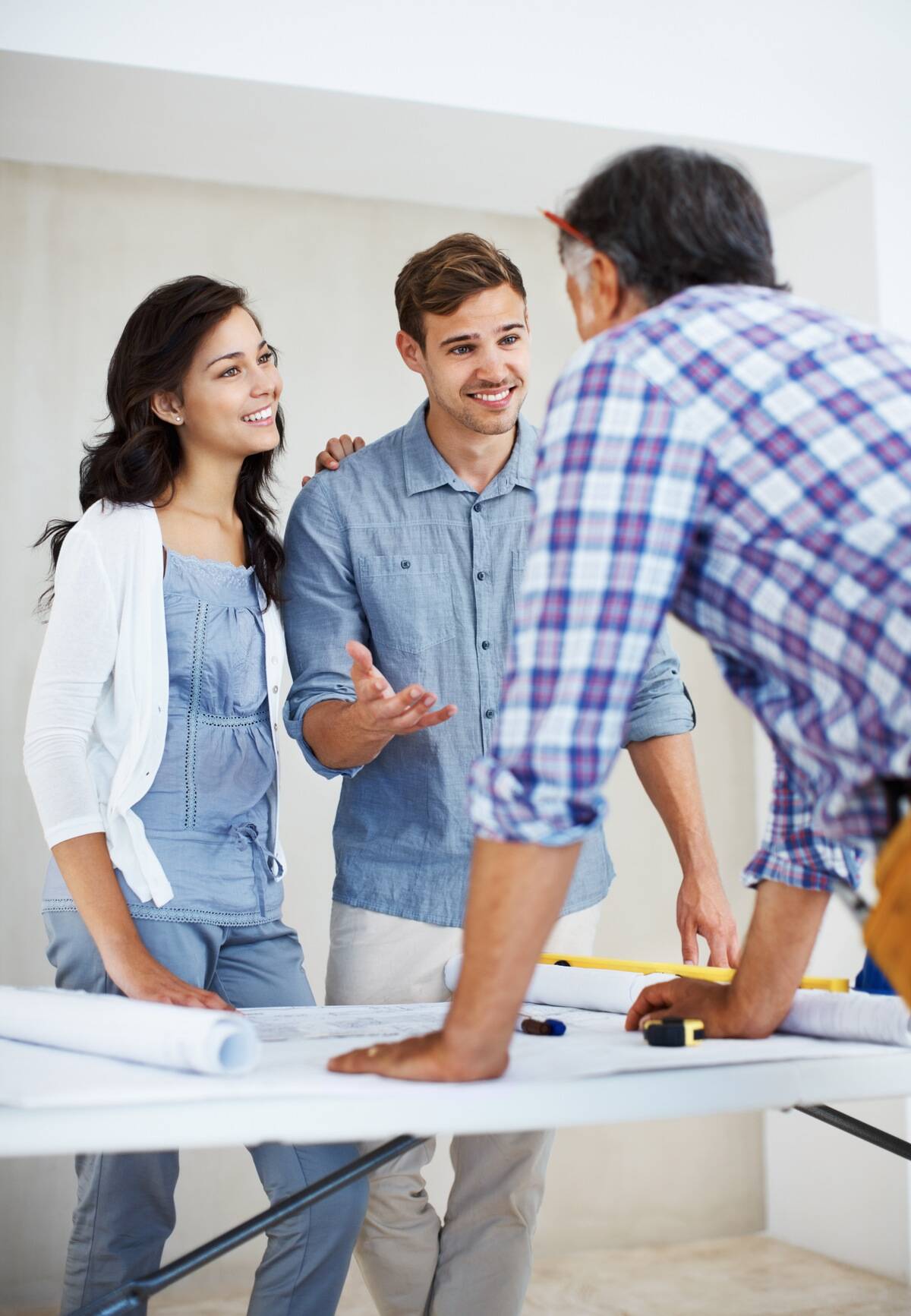 Couple speaking with an architect at a table