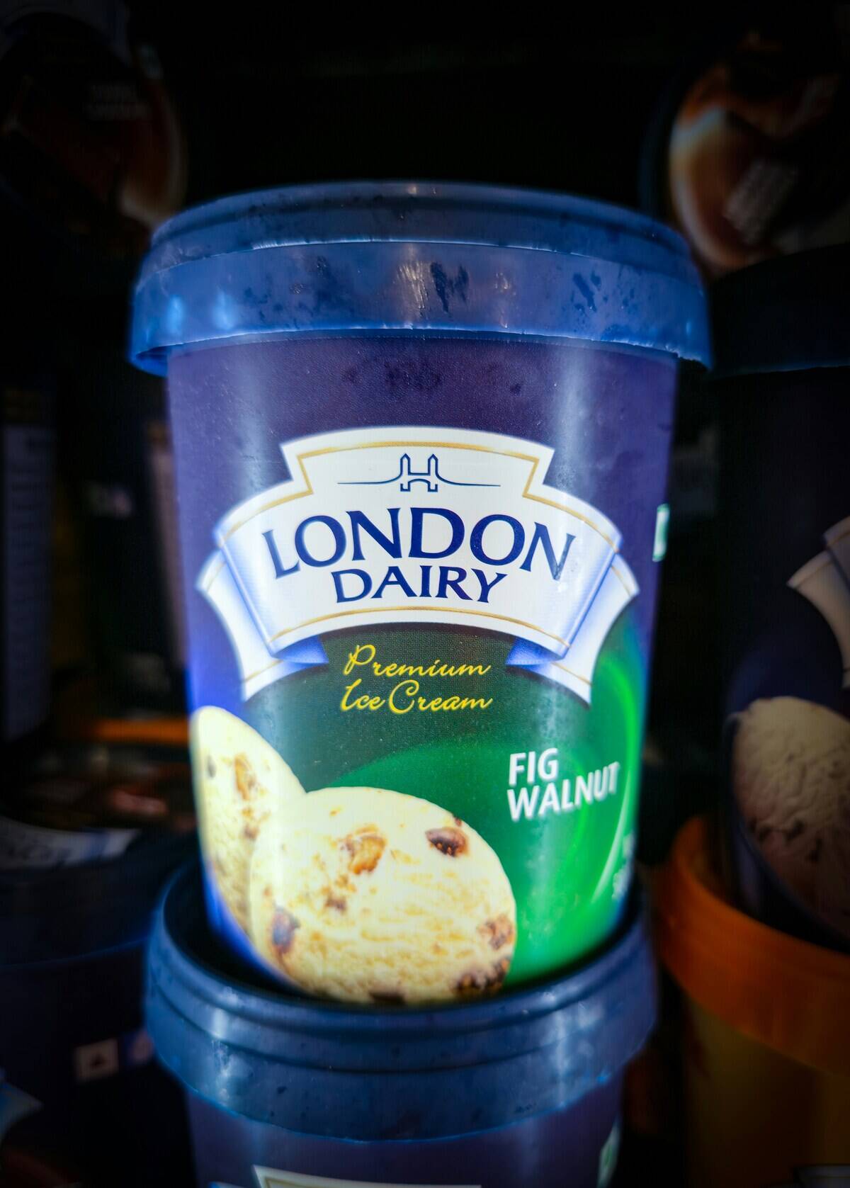 Containers of London Dairy fig walnut ice cream in a freezer