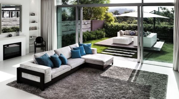 Contemporary home sports a stunning display of sliding glass doors that connect the living room with the world outside!